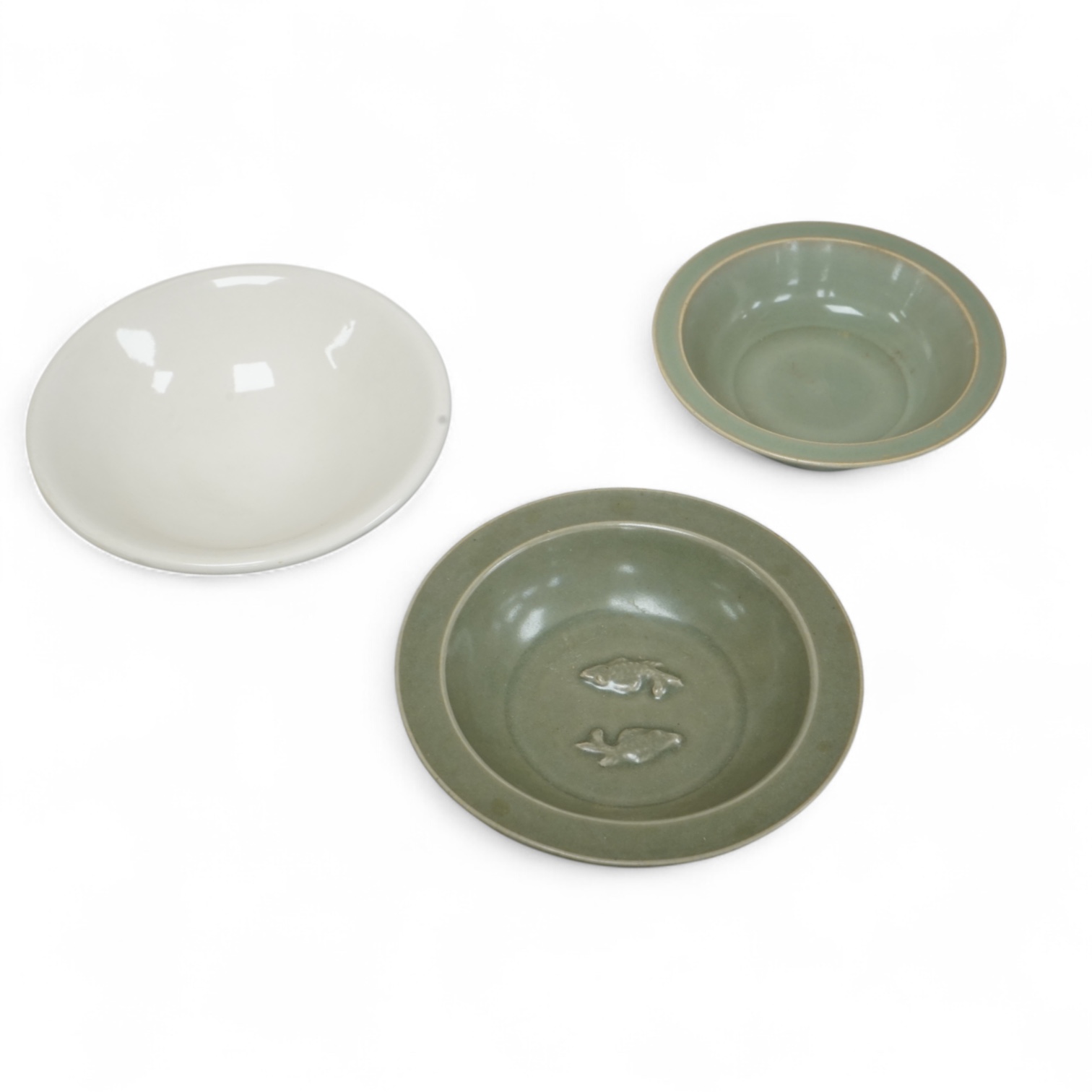 A Chinese celadon glazed twin fish dish, another similar and a white glazed bowl, largest 13.5cm